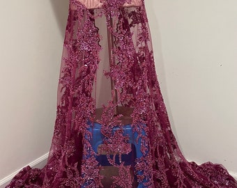 May include: Burgundy beaded lace fabric with a floral design. The lace is on a sheer mesh backing.