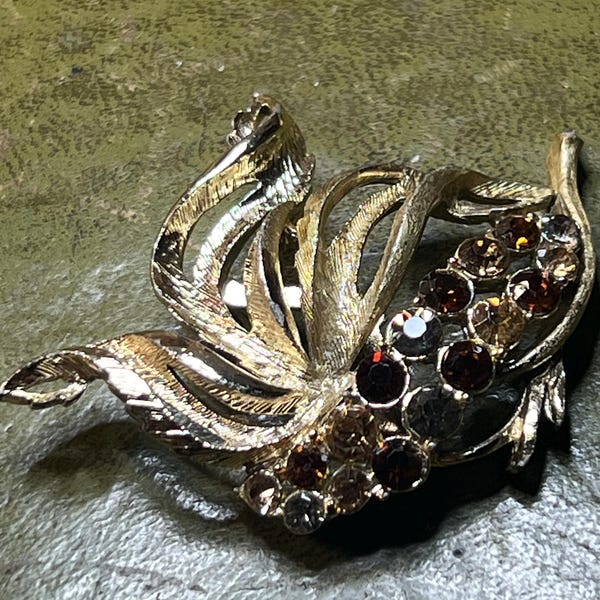 pretty metal and citrine glass brooch