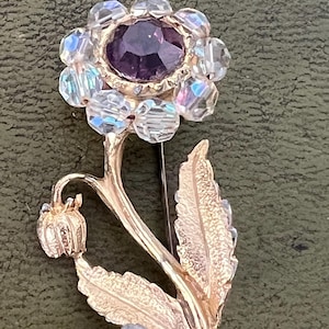pretty metal and glass flower brooch