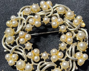 Metal and faux pearl brooch