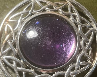 large metal and glass brooch