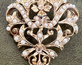 gold metal and glass brooch