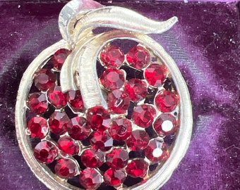 Metal and garnet glass brooch