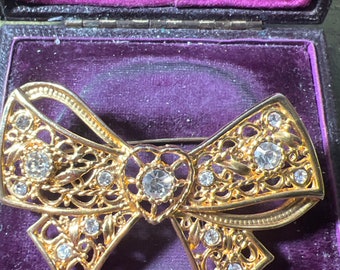 Metal and diamanté bow brooch
