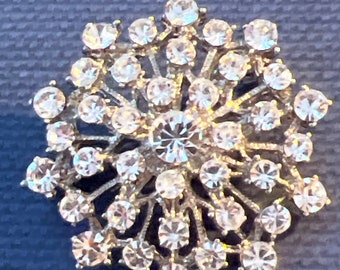 Metal no and diamanté brooch