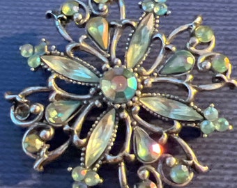 Metal and glass brooch