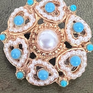 A pretty metal turquoise and seed pearl brooch