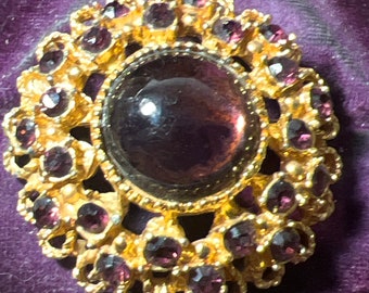 Metal and amethyst glass brooch