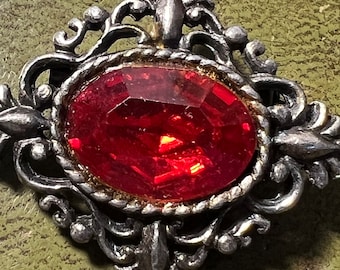 metal and glass brooch