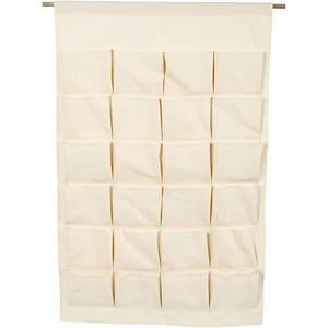 May include: Cream-coloured hanging organiser with multiple square pockets. The organiser is made of fabric and is suspended from a wooden rod. The pockets are arranged in rows and columns, providing storage for various items.