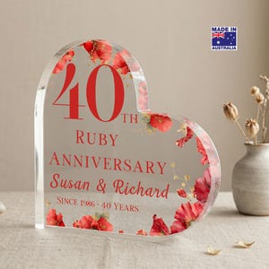 May include: A clear, heart-shaped acrylic plaque with red floral details, celebrating a 40th Ruby Anniversary. The plaque displays the text "40th Ruby Anniversary" and the names "Susan & Richard". Includes the text "Since 1986 - 40 Years".