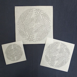 May include: Three different sizes of stencils featuring a circular design of stylised leaves. The stencils are made of a light brown paper and are perfect for crafting projects.