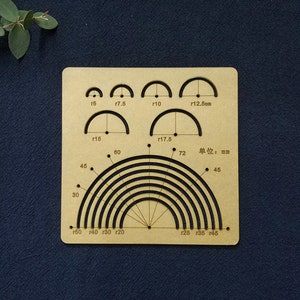 May include: A tan acrylic template featuring semi-circular cutouts and measurements in millimetres. The template includes arcs labeled r5, r7.5, r10, r12.5mm, r15, and r17.5. Additional markings indicate angles and radii.