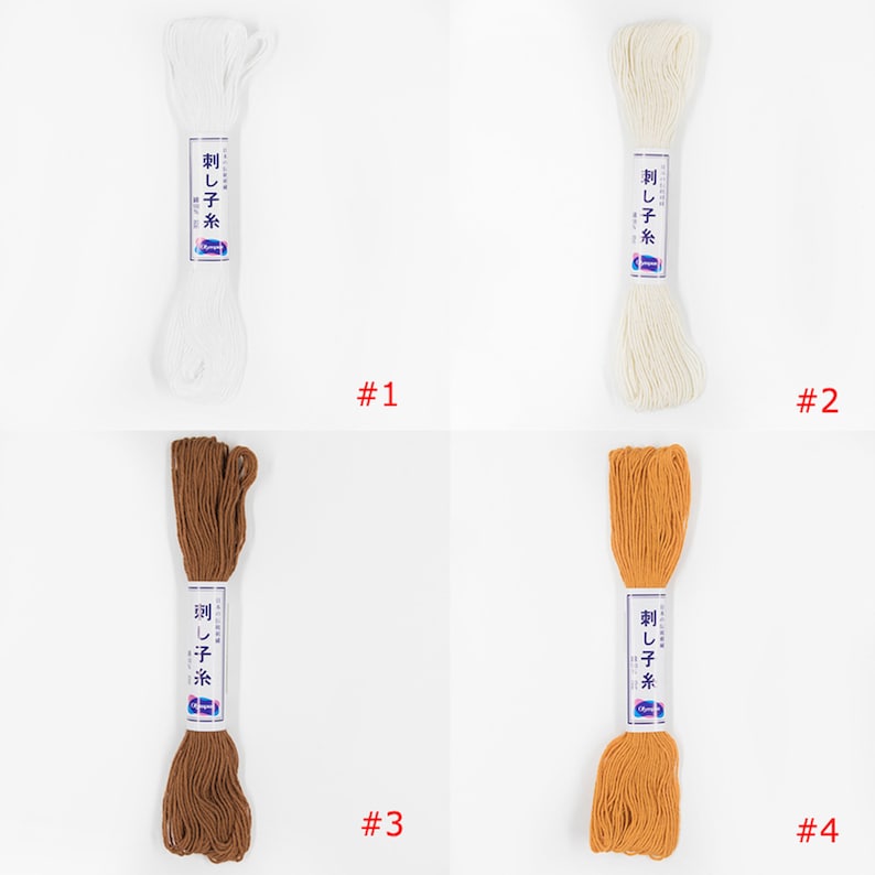 May include: Four spools of white, off-white, brown, and orange embroidery floss. Each spool is labelled "刺し子糸" in Japanese, which translates to "Sashiko thread".