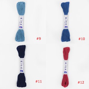 May include: Four spools of embroidery floss in different colours: light blue, dark blue, navy blue, and red. The spools are labelled "刺し子糸" which translates to "Sashiko thread". The numbers 9, 10, 11, and 12 are printed below each spool.
