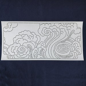 May include: A white paper stencil with a design of stylized waves and clouds. The design is made up of a series of connected dots.