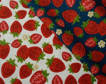 May include: Two fabric swatches with a repeating pattern of red strawberries on a white background and a blue background.