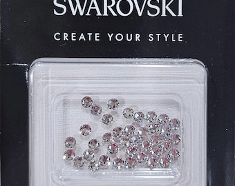 May include: A package of 38 clear, 3 mm Swarovski crystals for crafting. The package includes instructions for using the crystals with hot fix, termofijable, and glue methods. The package also includes a picture of a crystal and an iron.