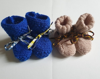 Hand knitted baby slippers with wax ribbon