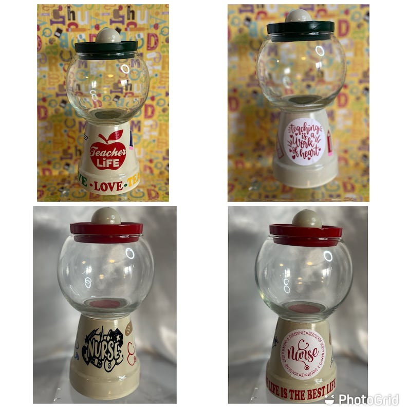 May include: Four glass candy dispensers decorated with painted designs. Two dispensers have red lids and feature a nurse theme with the text "Nurse Life is the Best Life". The other two dispensers have green lids and feature a teacher theme with the text "Teacher Life" and "Teaching is a Work of Heart".