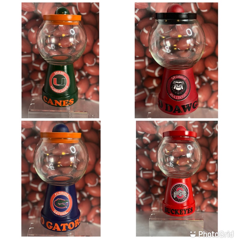 May include: Four different gumball machines decorated with college team logos. The gumball machines are made from terracotta pots and have glass jars. The logos are for the University of Miami Hurricanes, the University of Georgia Bulldogs, the University of Florida Gators, and the Ohio State Buckeyes.