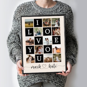 May include: A black framed photo collage with a white background. The collage features a grid of photos of a couple, with the letters "I LOVE YOU" spelled out in black squares. The names "mark" and "kate" are written below the collage, with a heart symbol between them.