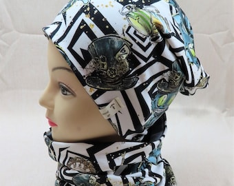 May include: A black and white patterned beanie and neck warmer with a whimsical design featuring gears, clocks, and a cat. The fabric has a subtle sparkle.
