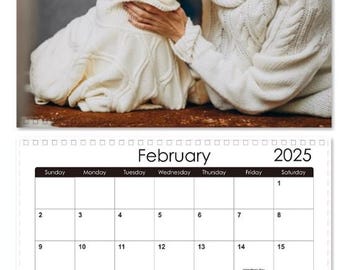 May include: A calendar for February 2025 with a photo of a woman kissing a white West Highland White Terrier dog. The calendar has the days of the week listed at the top and the numbers 1 through 28 listed in the grid.