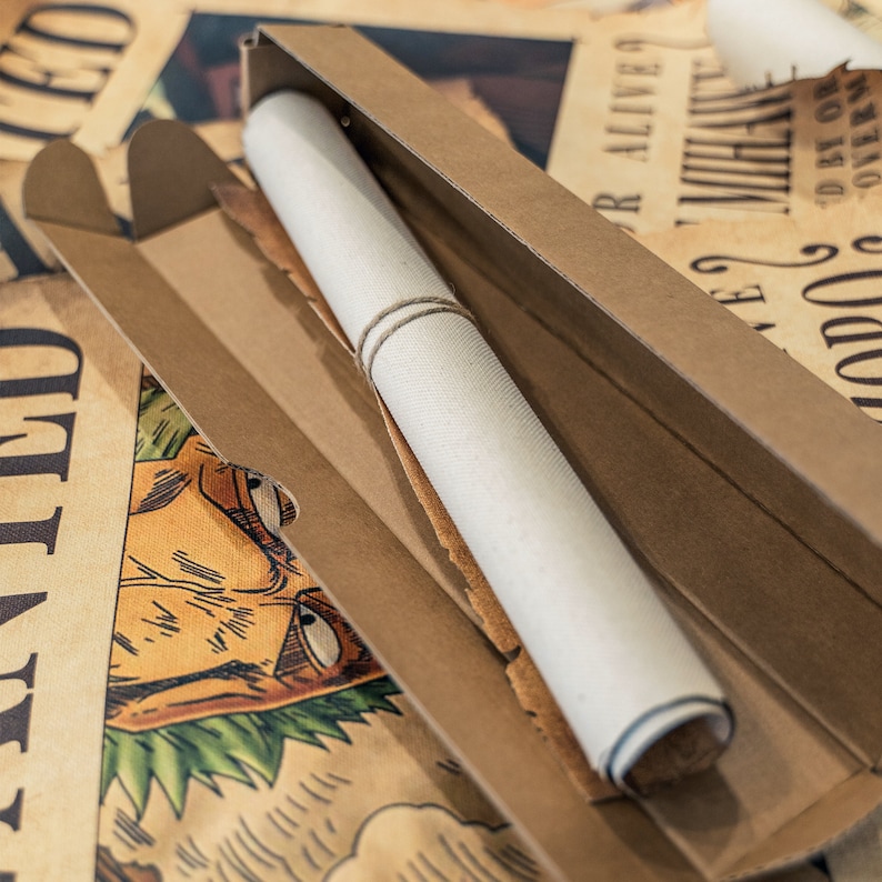 May include: A rolled-up poster in a cardboard tube. The poster is white and has a brown cardboard tube. The poster is sitting on a table with other posters.