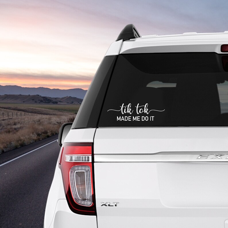 May include: White car with a black rear window and a white vinyl decal that reads "tik tok made me do it".