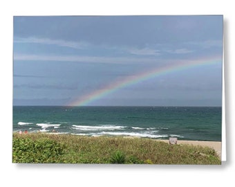 Rainbow at the beach designer greeting cards. Blank inside and can be customized. Sand, beach, waves and sky in Florida