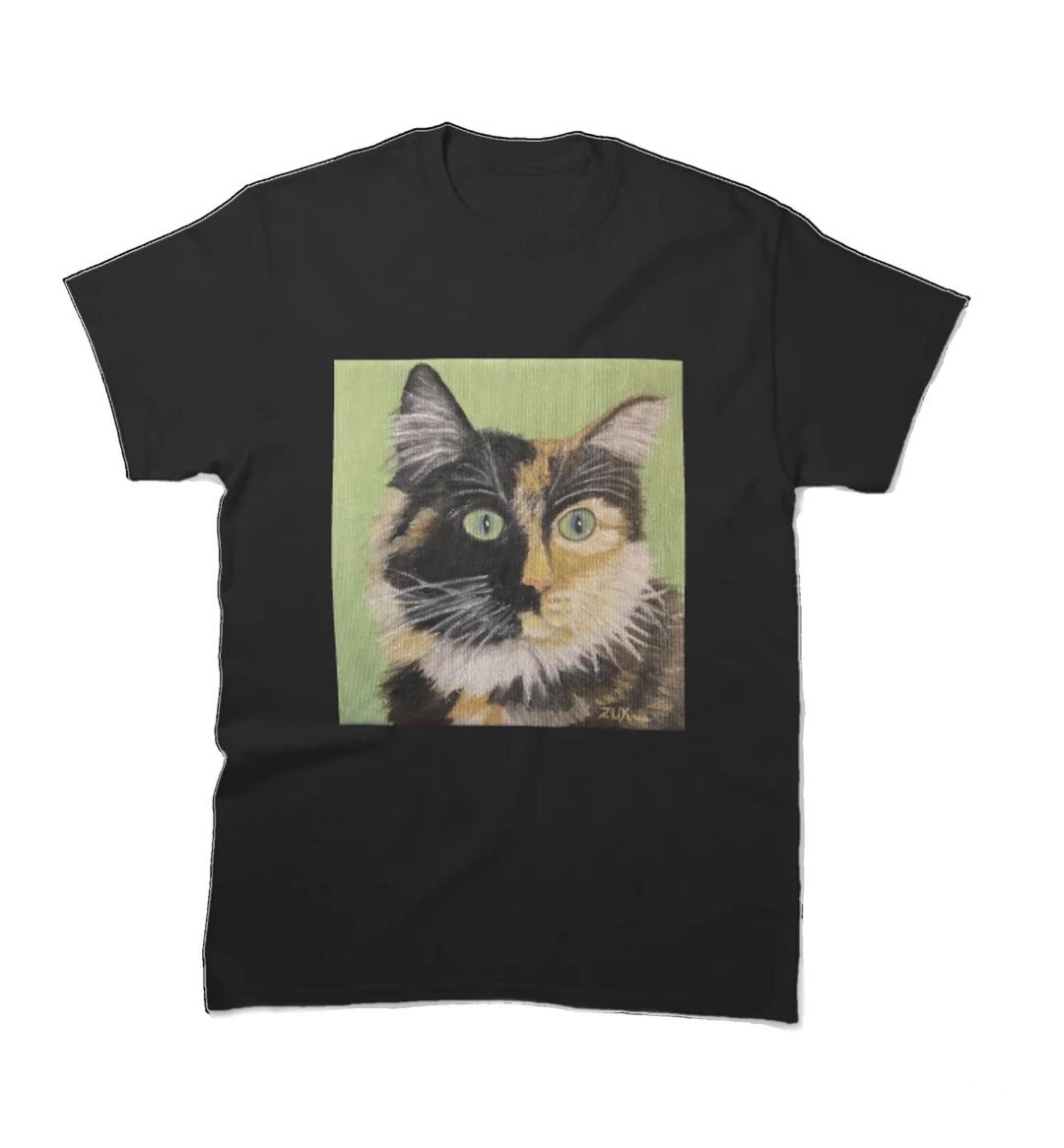 Tortie Cat Face T-shirt. Tortoiseshell Cat on Green Background. Close