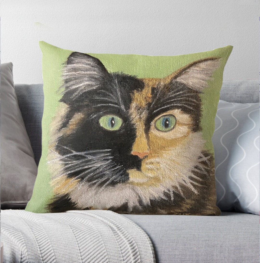 Tortie Cat Face Pillow. Tortoiseshell Cat on Green Background. Close up