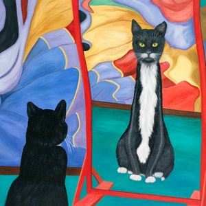 May include: A black and white cat with a long white stripe down its back sits in front of a red framed mirror. The mirror reflects a colorful abstract painting and the cat's reflection.