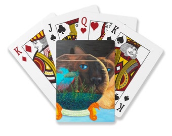 Siamese Cat and Betta Fish Playing Cards. Cat looks through a fishbowl. His eye is a bright turquoise. Orange glass seahorses at base.