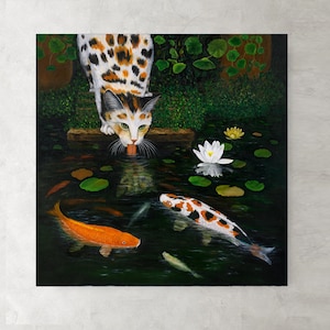 May include: A calico cat with green eyes drinks from a pond with lily pads and white flowers.  There are several orange and black koi fish swimming in the pond.