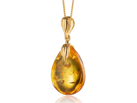 Honey Amber Circle w/Accented Sterling Silver Design on Bale Honey Amber Circle w/Accented Sterling Silver Design on Bale