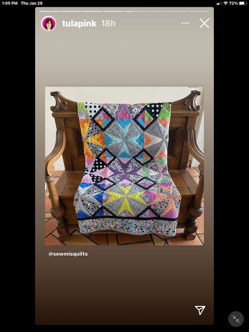 May include: A colorful quilt with geometric star and diamond patterns, draped over a wooden chair. The quilt features a variety of fabrics in shades of blue, yellow, pink, and gray, with black and white polka dot and floral accents. The text "tula pink" is visible.