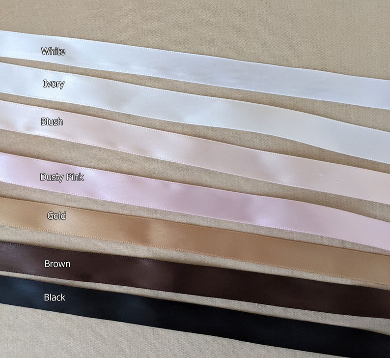 May include: A selection of satin ribbon in various colors, including white, ivory, blush, dusty pink, gold, brown, and black.