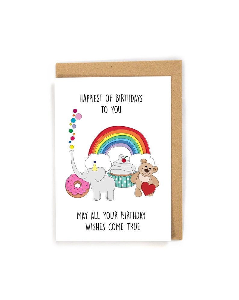 Puede incluir: Una tarjeta de cumplea&ntilde;os con un arco&iacute;ris, una dona, un cupcake, un osito de peluche y un elefante. La tarjeta dice "Happiest of Birthdays to You" y "May all your birthday wishes come true".