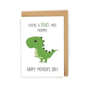 Peut inclure: Une carte blanche avec une illustration de dinosaure verte et le texte "You're a Dino-mite Mommy" et "Happy Mother's Day!"
