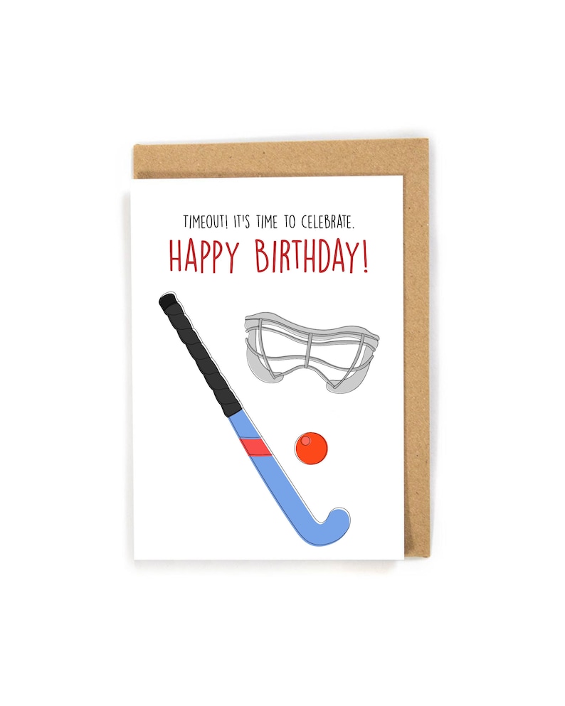 May include: A white card with the text "TIMEOUT! IT'S TIME TO CELEBRATE. HAPPY BIRTHDAY!" in red and black. A blue and black field hockey stick, a gray goalie mask, and a red ball are illustrated on the card.