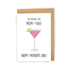 May include: A white card with the text "You deserve this MOM-TINI!" and a pink martini glass with a lemon twist. The card also says "Happy Mother's Day!"