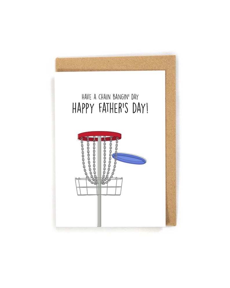 May include: A Father's Day card with a disc golf theme. The card features a cartoon illustration of a disc golf basket with a blue disc. The text reads, "Have a chain bangin' day! Happy Father's Day!" The card is in a kraft paper envelope.