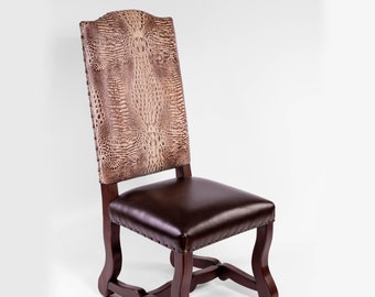 May include: A brown leather dining chair with a crocodile-embossed back and a dark brown seat. The chair has a carved wooden frame and a decorative design on the legs.