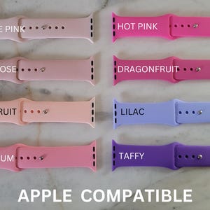 four different colors of apple watch bands on a marble surface