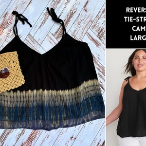 May include: Black tie-strap cami with a tie-dye pattern at the bottom. The cami is a size large.  REVERSE TIE-STRAP CAMI LARGE.