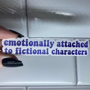 May include: A white sticker with blue text that reads "emotionally attached to fictional characters".
