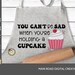 you can't be sad when you're holding a cupcake