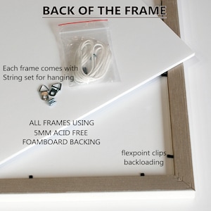 May include: The back of a white frame with a white foamboard backing. The frame includes a string set for hanging, two metal hooks, and two screws. The text "ALL FRAMES USING 5MM ACID FREE FOAMBOARD BACKING" is printed on the foamboard. The text "flexpoint clips backloading" is printed on the frame.
